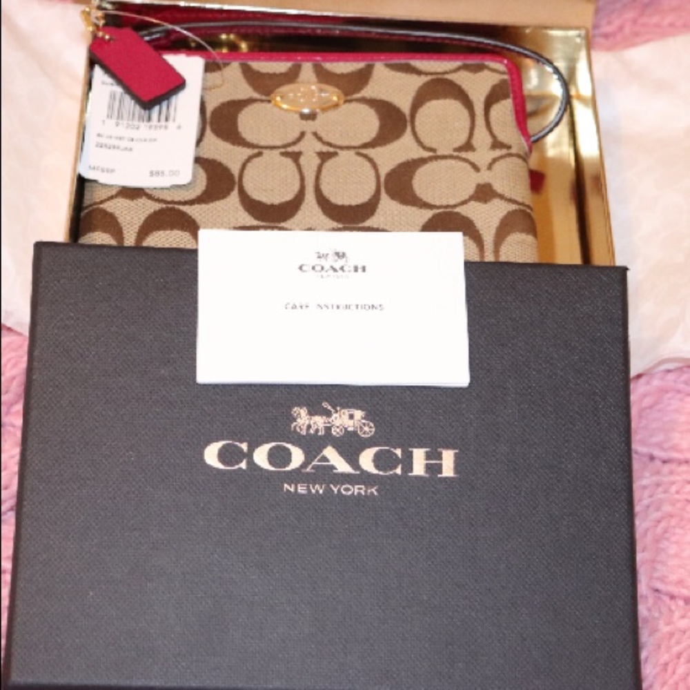 Pink and brown Authentic Coach wristlet 👛